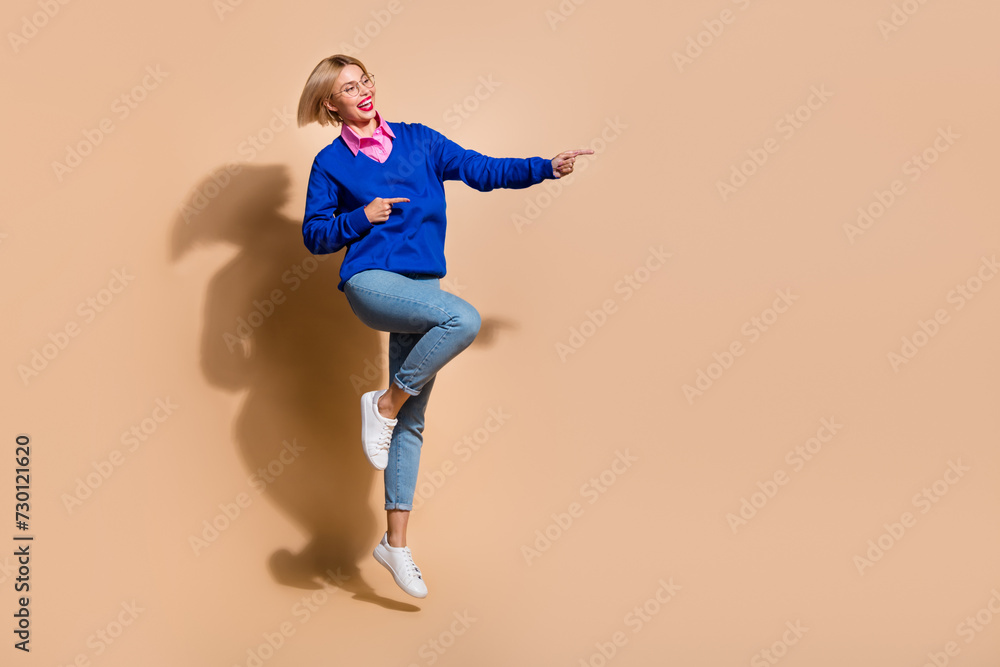 Full body length photo of business woman in formal wear direct fingers empty space new workplace isolated on beige color background