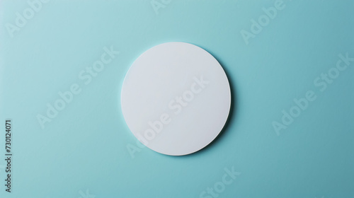 Blank round white sticker mockup on blue background