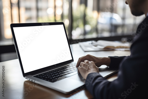 Businessman looking at an empty blank mockup screen, typing, planning, and analyzing data. Business technology concept