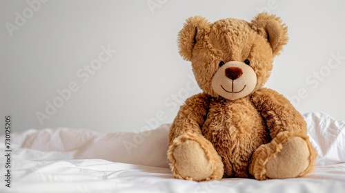 A brown teddy bear is positioned on a bed, showcasing its adorable presence and adding charm to the room. Generative AI