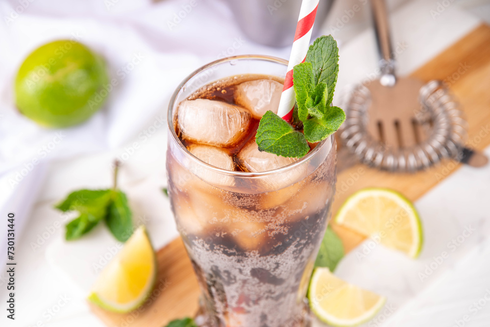 Fototapeta premium Cuba Libre or long island iced tea cocktail with strong drinks, cola, lime and ice in glass, cold long drink or lemonade