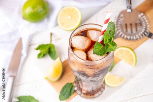 Cuba Libre or long island iced tea cocktail with strong drinks, cola, lime and ice in glass, cold long drink or lemonade