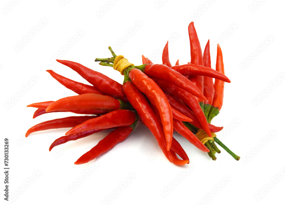 Stack red chili peppers and basil herb leaves on the white Stack red chili peppers and basil herb leaves on the white