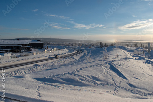 Idyllic panoramic view of a beautiful white winter wonderland scenery in Scandinavia with scenic golden evening light at sunset in winter, northern Europe.