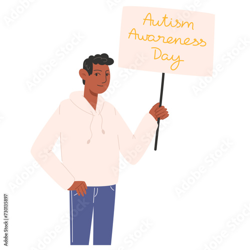 A man holding a poster for Autism Awareness Day