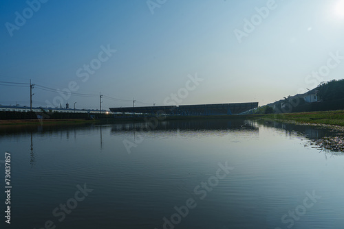 Solar Photovoltaic of solar farm view, solar plant rows array of on the water mount system Installation in earthen pond, water storage. Floating solar or floating photovoltaics (FPV)   © AU USAnakul+