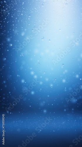 Abstract blue background with bokeh lights and falling snowflakes.