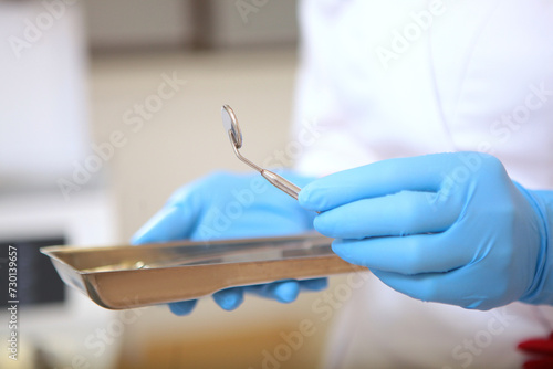 Dental instruments in the hands of an assistant. Modern dentistry. photo