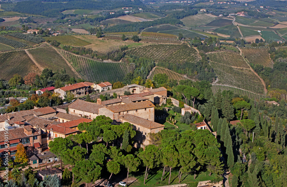 Aerial view of the terracotta rooftops and vineyards of San Gimignano in Tuscany