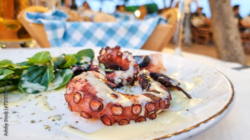 Closeup of a grilled octopus dish in a Greek taverna restaurant. photo