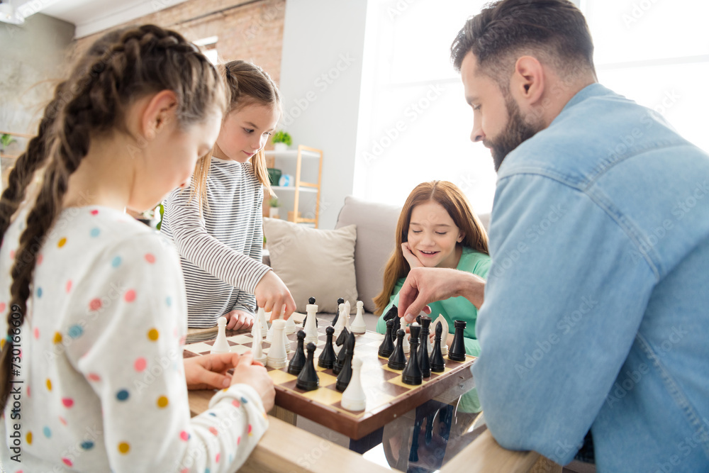 Portrait of nice intellectual focused cheerful family playing chess with alone dad free spare time at home house living-room indoors Portrait of nice intellectual focused cheerful family playing chess with alone dad free spare time at home house living-room indoors
