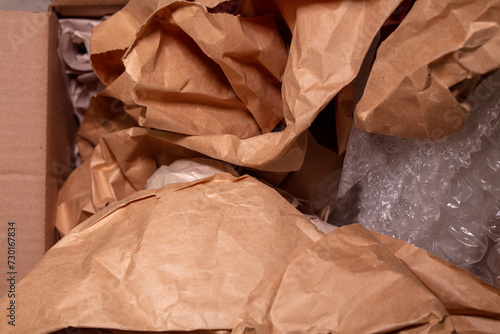Packing paper and plastic bubble wrap stuffed into a box moving or packing concept image