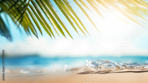 White sand of a tropical beach  palm leaves and bokeh highlights