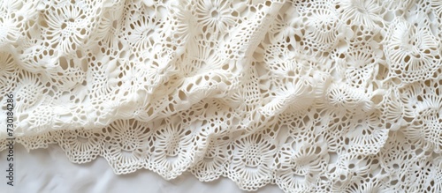 Handmade white openwork fabric, crocheted and knitted. photo