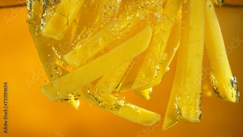 Freeze Motion of French Fries Floating in Cooking Oil.