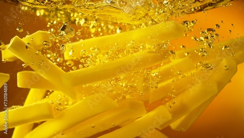 Freeze Motion of French Fries Floating in Cooking Oil. © Jag_cz
