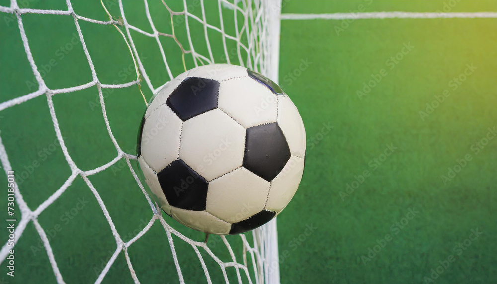 soccer ball in goal with green backgroung soccer ball in goal with green backgroung
