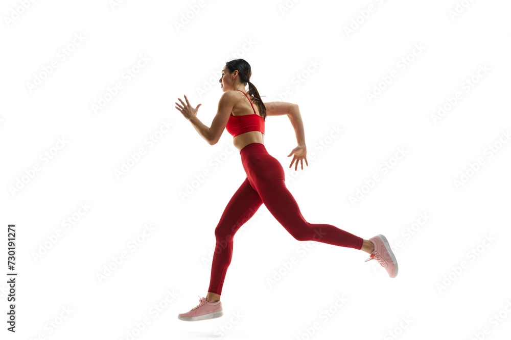 Dynamics, endurance and energy. Female runner athlete in motion, running, training against white studio background. Concept of sport, active and healthy lifestyle, sportswear, competition Dynamics, endurance and energy. Female runner athlete in motion, running, training against white studio background. Concept of sport, active and healthy lifestyle, sportswear, competition
