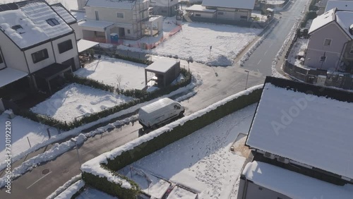 Aerial - Following a delivery van dropping of the packages driving trough suburb