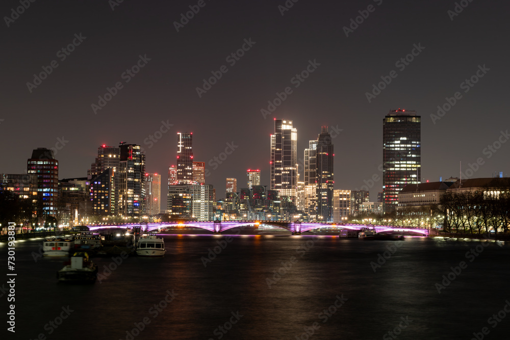 Fototapeta premium London. UK- 02.04.2024. A general night time view of the capital's skyline from Westminster Bridge of the Thames river and modern high rise office buildings.