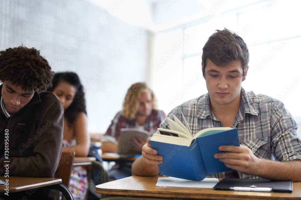 University, book and man in classroom reading for development in learning, opportunity and future career. Education, knowledge and growth for college student in lecture, studying for exam or test. University, book and man in classroom reading for development in learning, opportunity and future career. Education, knowledge and growth for college student in lecture, studying for exam or test.