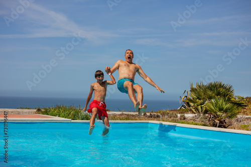 Pool jump with ocean view, dad and son summer fun on vacations