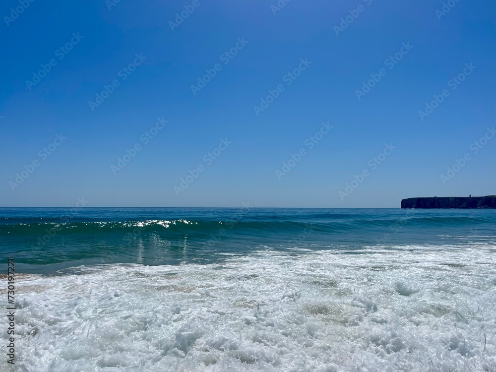 Blue sea horizon, sandy seashore, natural sea background, clear sky Blue sea horizon, sandy seashore, natural sea background, clear sky
