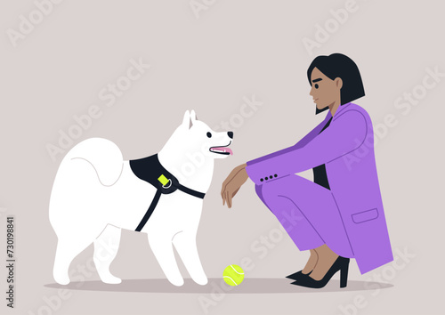 A woman in a stylish purple suit kneels down to interact with her white, attentive dog, as a yellow ball awaits the fun they are about to have