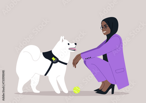 A woman in a stylish purple suit kneels down to interact with her white, attentive dog, as a yellow ball awaits the fun they are about to have