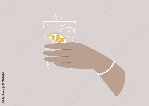 A hand gracefully cradles a crystal glass filled with pure, glistening water, capturing the essence of replenishment and hydration