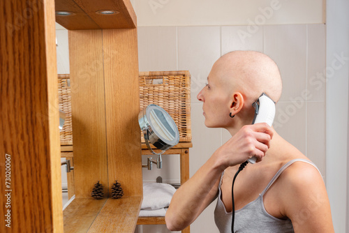Woman without hair struggle with cancer shaves scalp in mirror