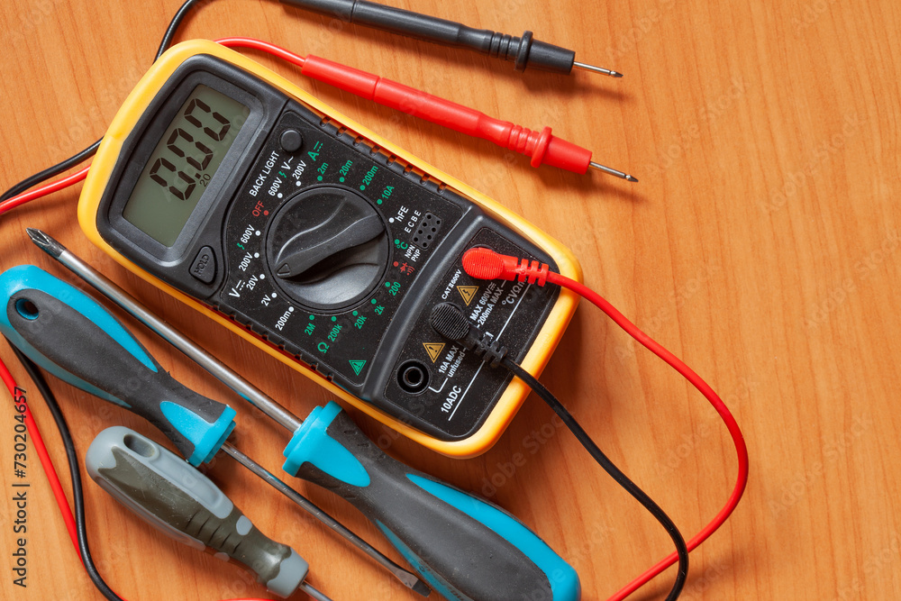 Digital multimeter and screwdrivers Digital multimeter and screwdrivers