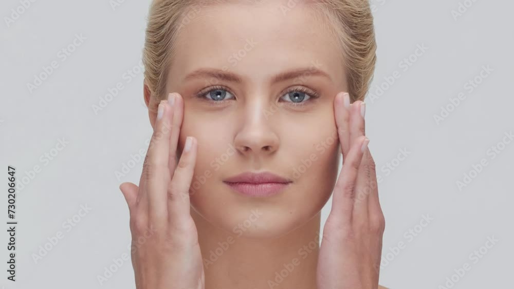 Studio portrait of young, beautiful and natural blond woman applying skin care cream. Face lifting, cosmetics and make-up concept. Studio portrait of young, beautiful and natural blond woman applying skin care cream. Face lifting, cosmetics and make-up concept.