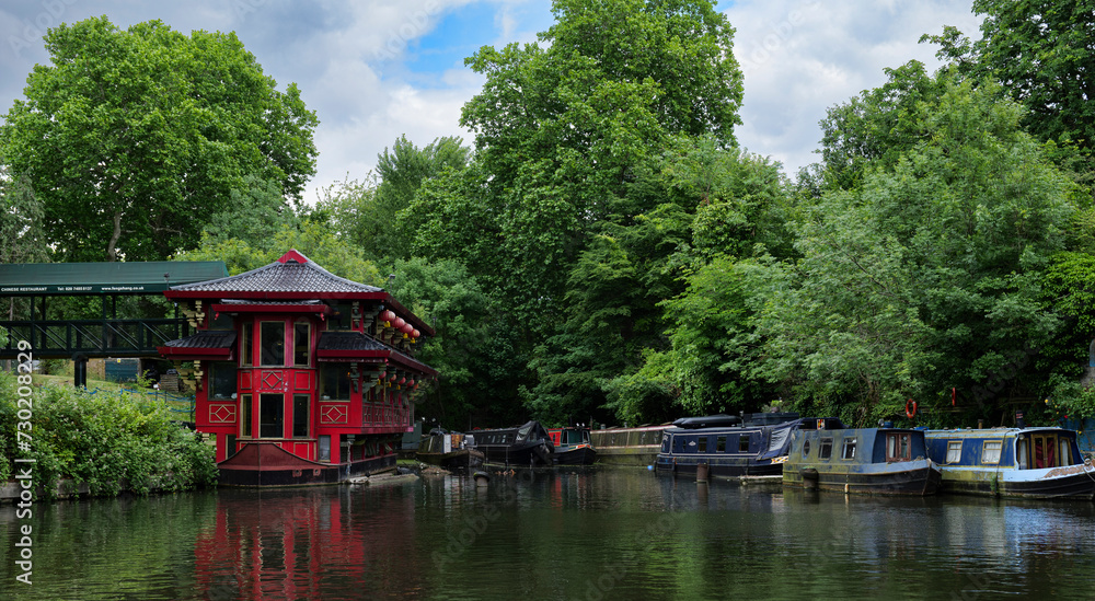 London - 29 05 2022: The Chinese Pagoda in the Cumberland Basin on the Regent's Canal with houseboats. London - 29 05 2022: The Chinese Pagoda in the Cumberland Basin on the Regent's Canal with houseboats.