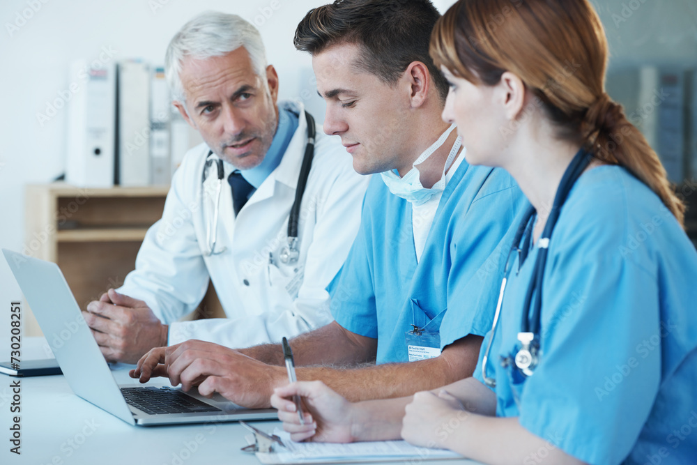 Laptop, discussion and doctor with nurses in hospital for medical diagnosis or treatment meeting. Team, computer and senior surgeon talking to healthcare workers for surgery research in clinic. Laptop, discussion and doctor with nurses in hospital for medical diagnosis or treatment meeting. Team, computer and senior surgeon talking to healthcare workers for surgery research in clinic.