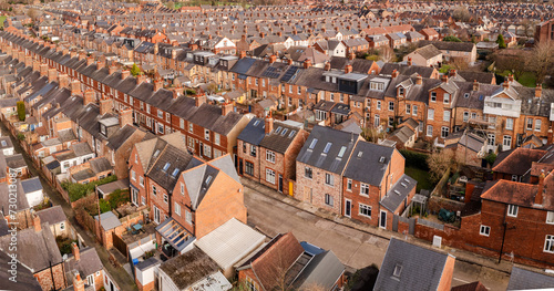 Aerial view above rows of back to back terraced houses on a large council estate
