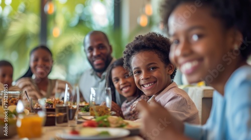 A joyful family sharing a meal, smiling, in a bright setting.