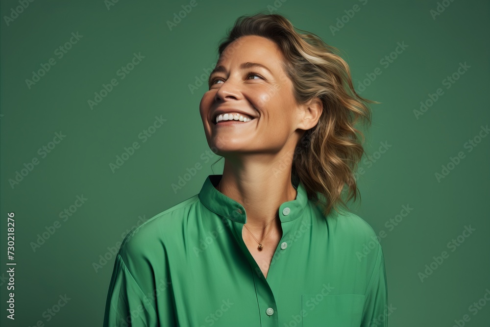 Portrait of happy mature woman in green shirt on green background. Portrait of happy mature woman in green shirt on green background.