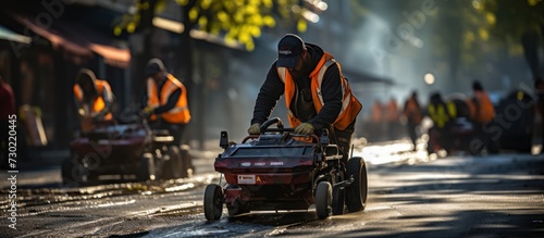 rear view Road workers use a hot melt machine to paint dividing lines on the road surface