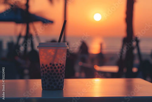 Boba tea with tapioca balls. Boba tea silhouetted against a sunset background, refreshing, summery, romantic © Olga