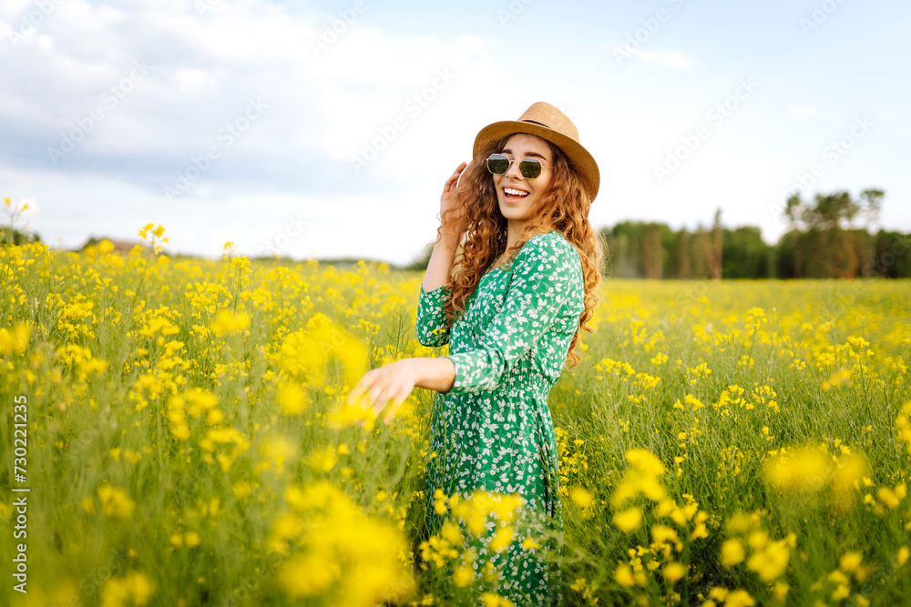 Beautiful woman walking in the blooming field at sunny summer day. Nature, vacation, relax and lifestyle. Summer landscape. Beautiful woman walking in the blooming field at sunny summer day. Nature, vacation, relax and lifestyle. Summer landscape.