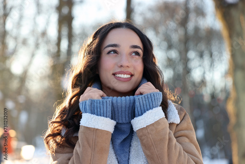 Portrait of smiling woman in winter snowy park