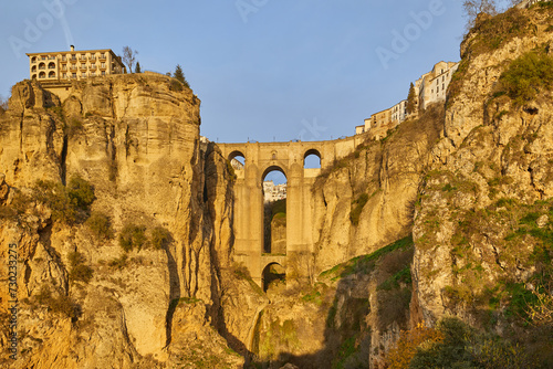 The new bridge of the village of Ronda in the rays of the setting sun. Andalusia, Spain.