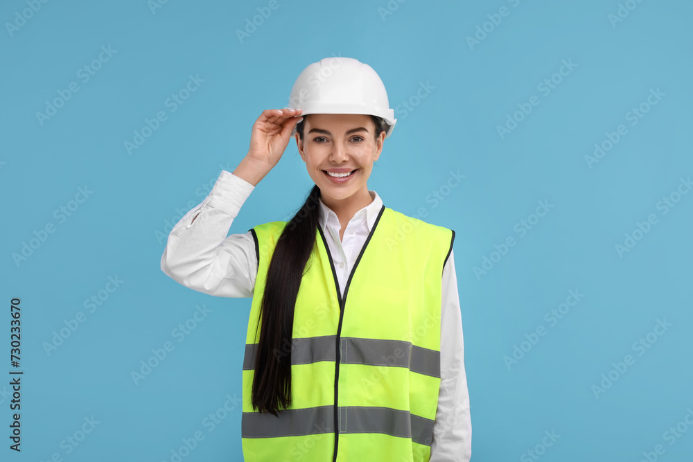Engineer in hard hat on light blue background Engineer in hard hat on light blue background