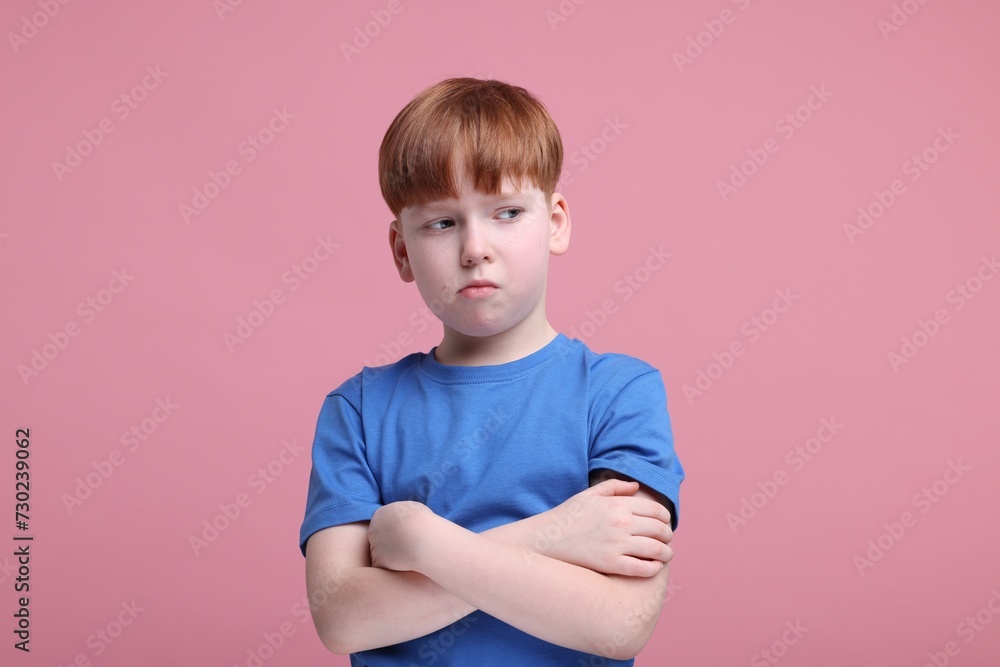 Portrait of sad little boy on pink background Portrait of sad little boy on pink background