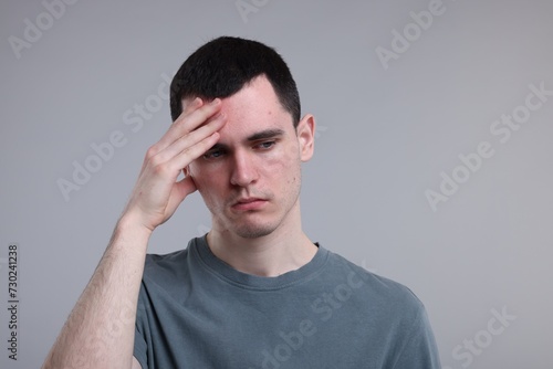 Portrait of sad man on grey background