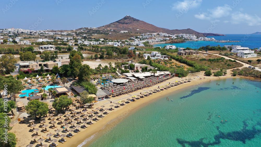 Aerial drone photo from sandy organised with umbrellas and sun beds beach of Pounta with crystal clear emerald sea, Paros island, Cyclades, Greece