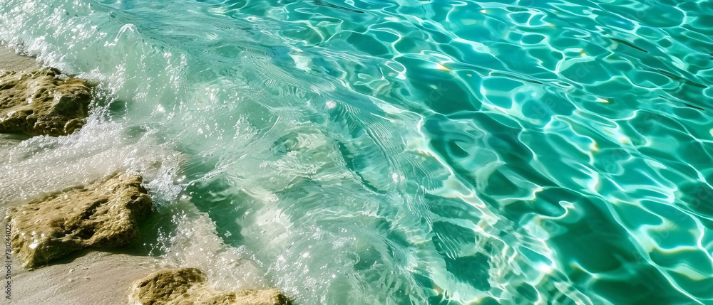 Serene ripples on a clear turquoise water surface, reflecting sunlight