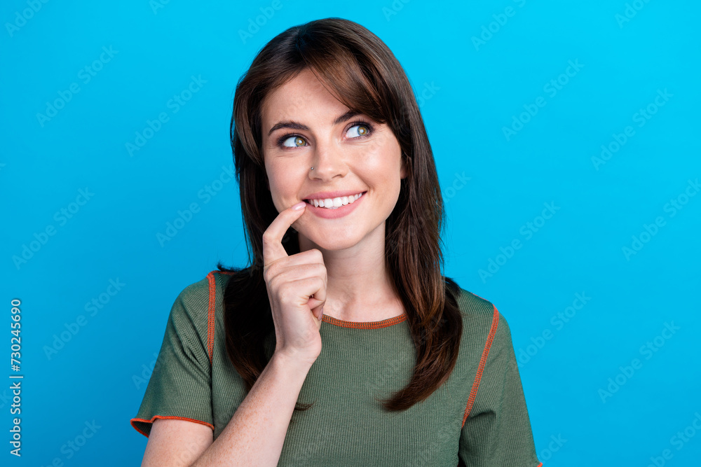 Portrait of cute cheerful person toothy smile finger touch lips look empty space isolated on blue color background Portrait of cute cheerful person toothy smile finger touch lips look empty space isolated on blue color background