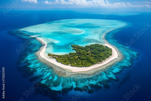 Aerial view of a pristine coral atoll with a turquoise lagoon surrounding it